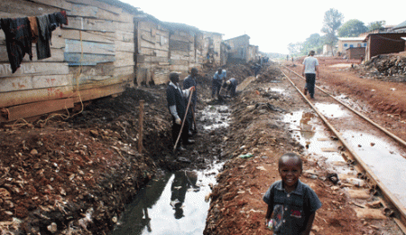 clearing rubbish from drainages Kampala slums