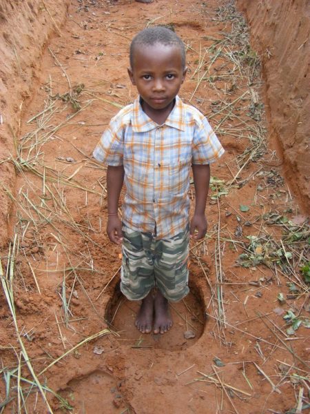 boy in elephant trench Ishasha Queen Elizabeth National Park boy in elephant trench Ishasha Queen Elizabeth National Park
