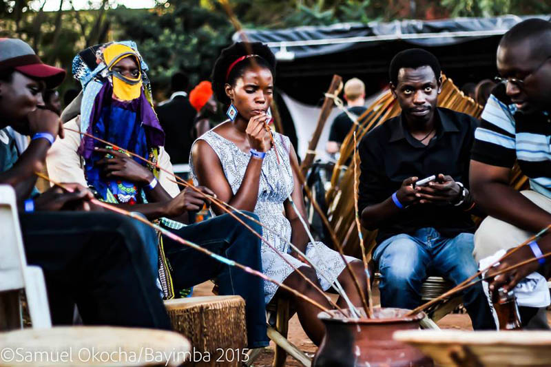 Drinking local brew. Bayimba International Festival of the Arts. Samuel Okocha