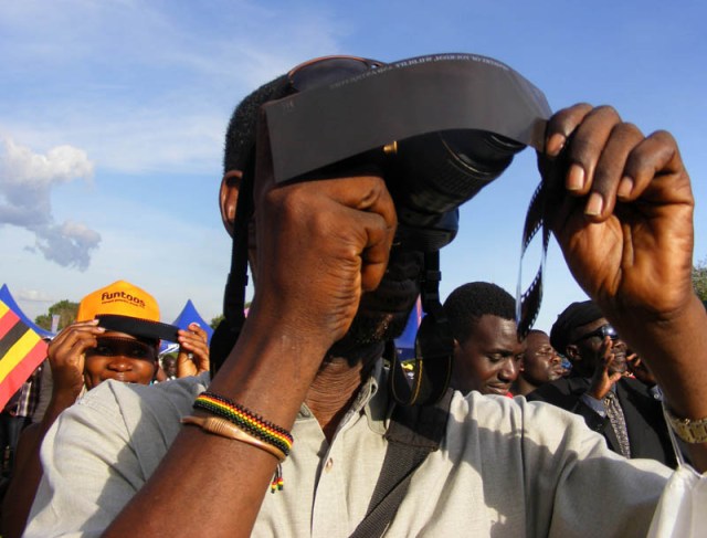 Hashers of the Eclipse - we should have had a Circle in Pokwero! The competition for the maximum number of cameras, phones, goggles and miscellaneous protective eye gear is hotting up! Man photographing solar eclipse, Uganda