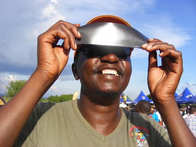 Hashers of the Eclipse part 2 - we should have had a Circle in Pokwero! The competition for the maximum number of cameras, phones, goggles and miscellaneous protective eye gear is hotting up! Man looking at solar eclipse