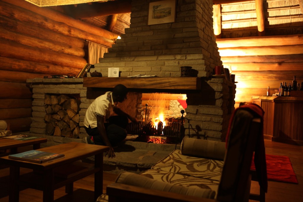lighting fire Kyaninga Lodge living area