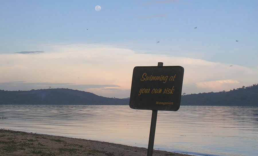 Signpost "swimming at your own risk", Munyonyo, Lake Victoria