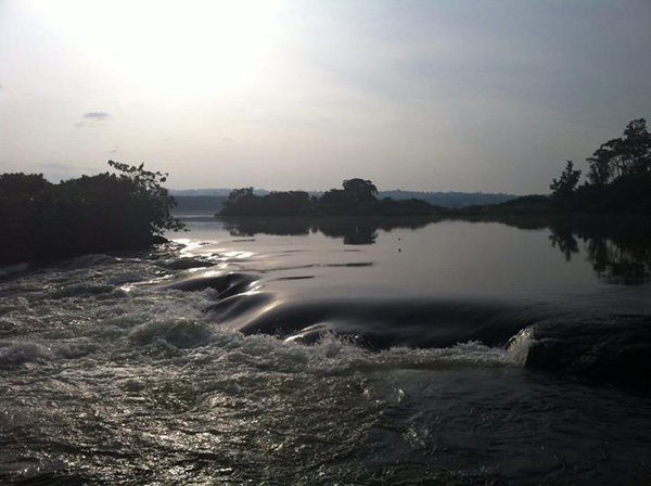 Like melted chocolate, the River Nile flows over the rocks below The Haven at Jinja. The Haven Lodge Jinja River Nile