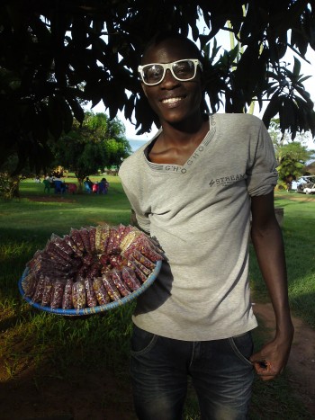 Beautifully wrapped packets of g nuts (ground nuts) arrived just in time to go with my beer, courtesy of this friendly young man with very cool shades. Beach House Event Gardens, Ggaba. Guide to eating fish, Lake Victoria - Diary of a Muzungu